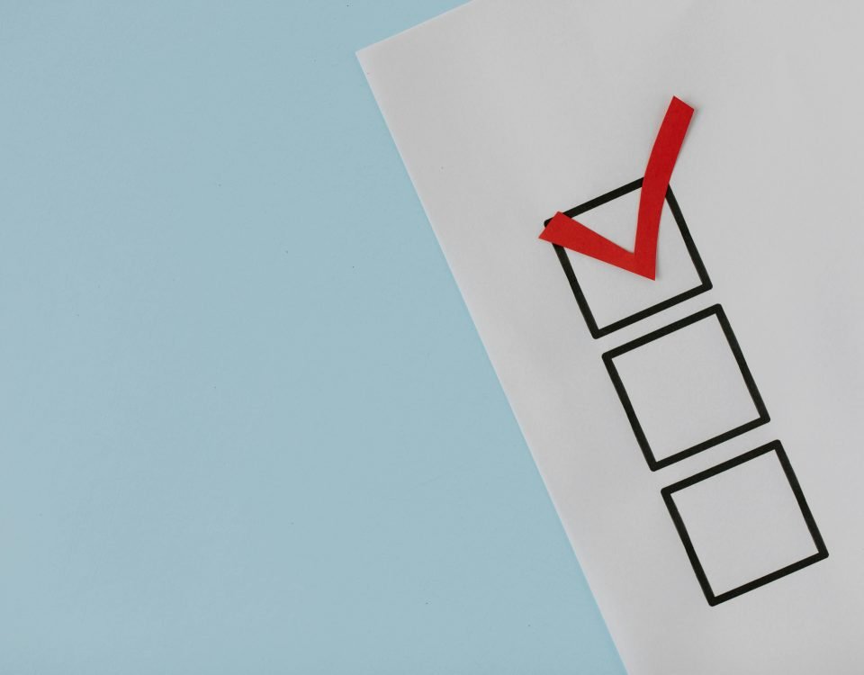 A simple white paper checklist with one red checkmark, ideal for concepts like completion or approval.