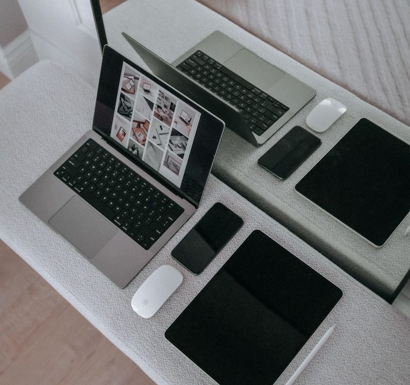 A laptop computer sitting on top of a white table